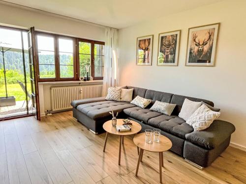 a living room with a couch and two tables at Apartment Tannenblick by Interhome in Todtmoos