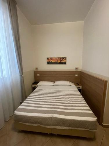 a bedroom with a large bed in a room at Hotel Montecarlo in Milan