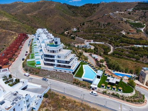 an aerial view of a large white building with a road at Apartment Collection View Free Spa & Padel by Interhome in Torrox Costa