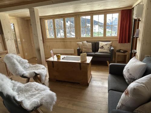 a living room with a couch and a coffee table at Apartment Alpenchalet Haldeli by Interhome in Gstaad