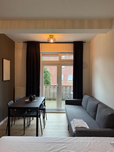 a living room with a couch and a table at Central Studios in The Hague