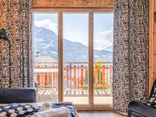 a room with a large window with a view of a mountain at Studio Beau Soleil G11 by Interhome in Veysonnaz