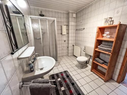 a bathroom with a sink and a shower and a toilet at Apartment Krüger-2 by Interhome in Großheide