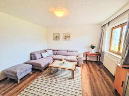 a living room with a couch and a table at Apartment Dinkl by Interhome in Stummerberg