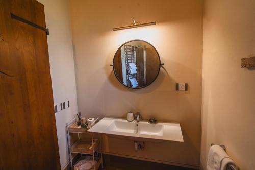 a bathroom with a sink and a mirror at Agriturismo Sole in Trequanda