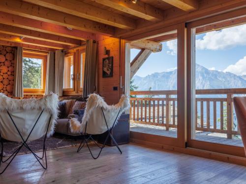 a living room with a couch and chairs on a balcony at Chalet Etoile by Interhome in Nendaz