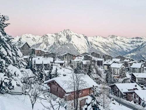 a town covered in snow with mountains in the background at Chalet Etoile by Interhome in Nendaz