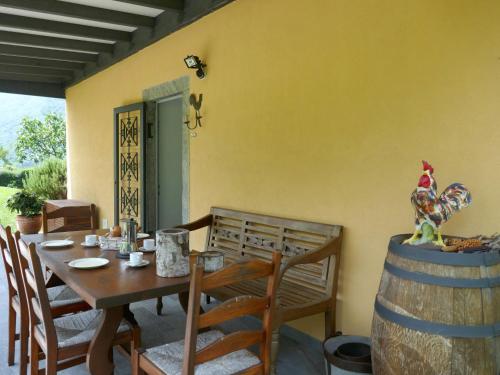 a dining room with a table and a wooden chicken on a barrel at Holiday Home La Monda by Interhome in Malvaglia