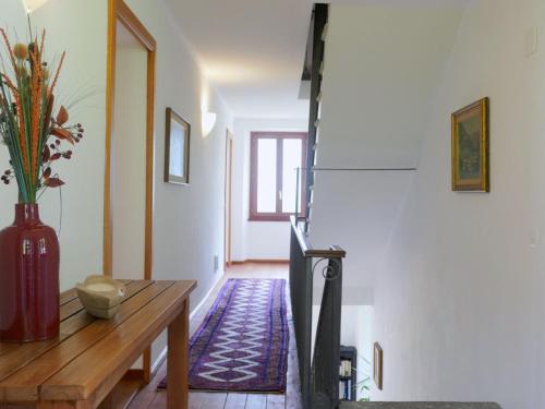 a hallway with a table and a vase on the floor at Holiday Home La Monda by Interhome in Malvaglia