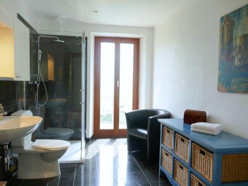 a bathroom with a toilet and a sink and a shower at Holiday Home La Monda by Interhome in Malvaglia