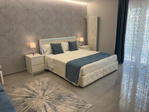 a bedroom with a large bed with two night stands at Ranieri Guest House in Celano