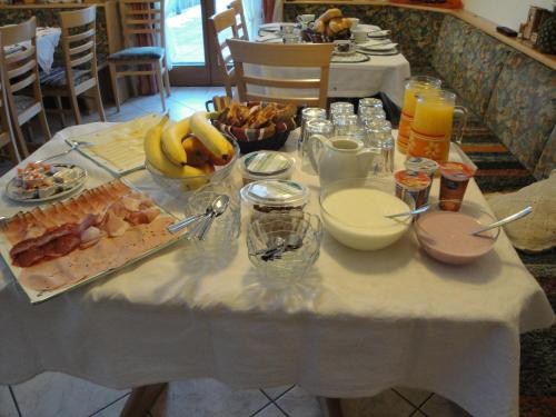 a table with a white table cloth with food on it at Bio Angererhof in Bad Häring
