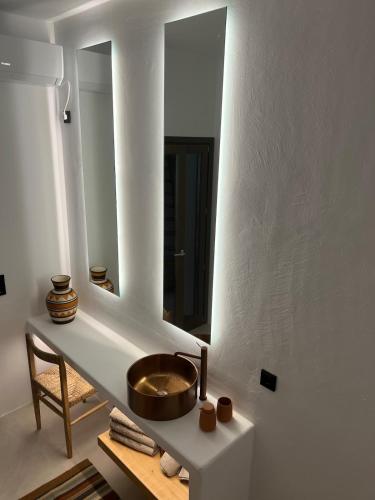 a bathroom with a sink and a mirror at Estrella house in Kithnos