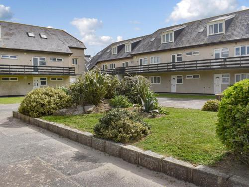 a row of apartment buildings with bushes in front of them at Beach House in Perranporth