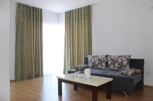 a living room with a couch and a coffee table at Prenoćište Stanica in Bosanska Krupa