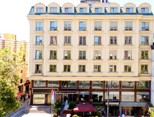 a large white building on a city street at Kent Hotel in Istanbul
