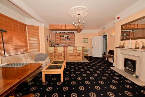 a living room and kitchen with a couch and a table at Lyme Bay House in Dawlish