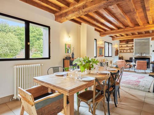 a dining room with a wooden table and chairs at Holiday Home Villa Honfleur by Interhome in Gonneville-sur-Honfleur