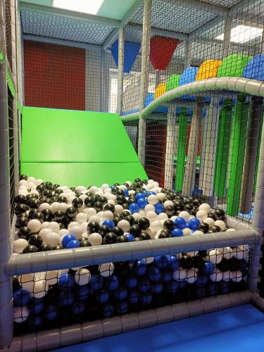 a cage full of birds with blue balls in it at Hotel Adam & Spa in Kudowa-Zdrój