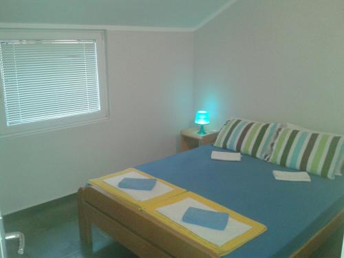 a bedroom with a bed and a window and a table at Apartments Dakovic in Kotor