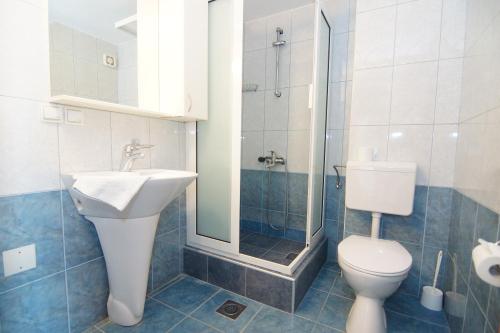a bathroom with a toilet and a sink and a shower at Blue Palace Guest House in Budva