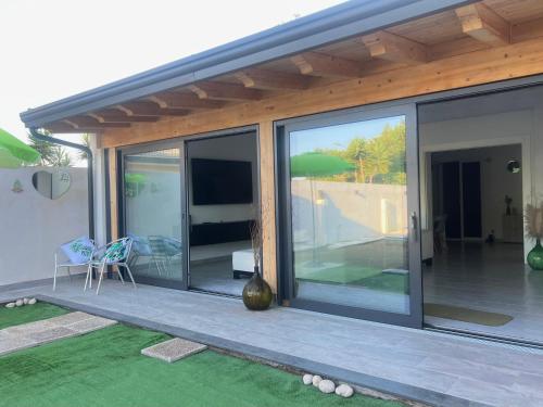 a house with sliding glass doors on a patio at Villa Leonessa in Tremestieri Etneo