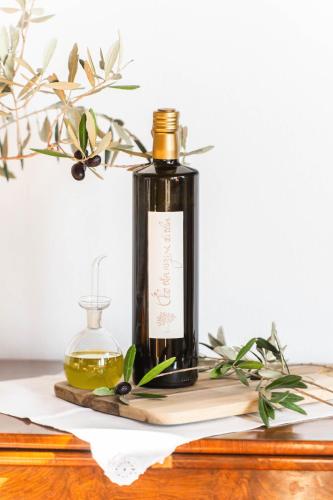 a bottle of olive oil on a wooden table at Agriturismo Sole in Trequanda