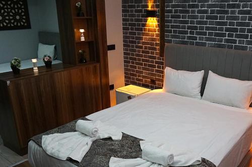 a bedroom with a bed with towels on it at Emir City Hotel in Bursa