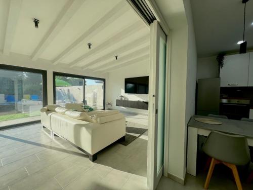 a living room with a white couch and a table at Villa Leonessa in Tremestieri Etneo