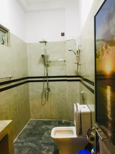 a bathroom with a shower and a toilet at Rest N surf Apartments in Ahangama