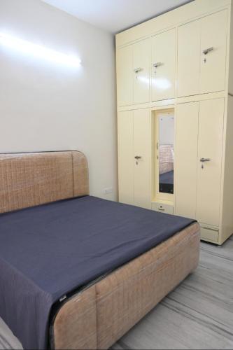 a bedroom with a bed and white cabinets at The Villas Homestay in Jammu