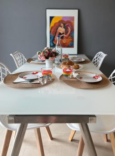 a white dining table with plates and food on it at Roseto Marina Vista Monte in Roseto degli Abruzzi