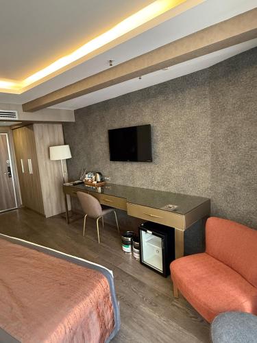 a hotel room with a desk and a bed at Ayramin Deluxe Hotel Taksim in Istanbul