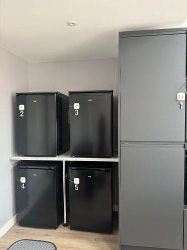 a room with three refrigerators sitting on a shelf at Ravenscourt Rooms by Brabazon Rooms in Bristol