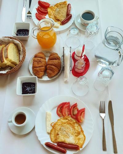 a white table topped with plates of breakfast foods at Gurguri Hotel in Golem