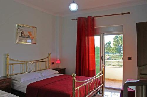 a bedroom with a bed and a sliding glass door at Gurguri Hotel in Golem