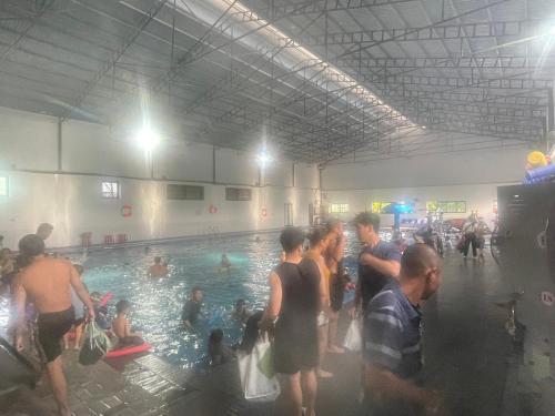 a group of people standing around a swimming pool at Nhà nghỉ Xuân Long - Xuan Long gues - Tỉnh Điện Biên in Ban Hin Lom