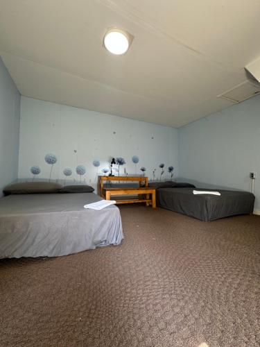 a room with two beds and a table in it at Thessalon Luxury House -Space Share in Thessalon