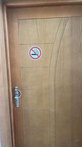 a door with a no smoking sign on it at Dar Hella Apartments in El Maamoura
