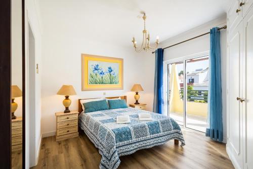 a bedroom with a bed and a large window at Vila Sophia, Vilamoura- By Urbinvest Algarve in Vilamoura