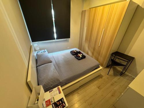 a small bed in a small room with a window at Homes in Ancona CCA23 Rooms in Ancona