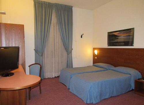 Postel nebo postele na pokoji v ubytování Hotel Giardino