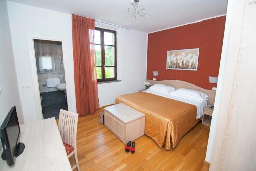 Ένα ή περισσότερα κρεβάτια σε δωμάτιο στο Hotel la Colonna Siena