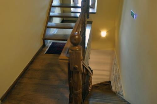 a spiral staircase in a house with a stair case at Archontiko Leontari in Leondari