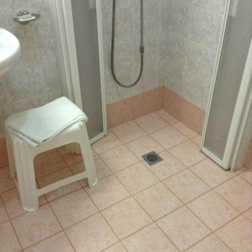 a bathroom with a shower with a stool and a shower at Hotel Residence Imperial in Misano Adriatico