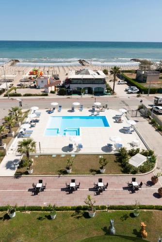 an aerial view of a resort with a pool and the beach at Hotel Residence Imperial in Misano Adriatico