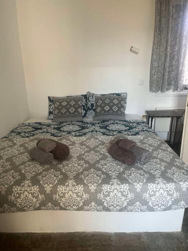 a bedroom with a bed with two slippers on it at Cozy house by the sea in Batsi