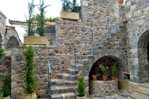 a stone wall with potted plants on it at Archontiko Leontari in Leondari