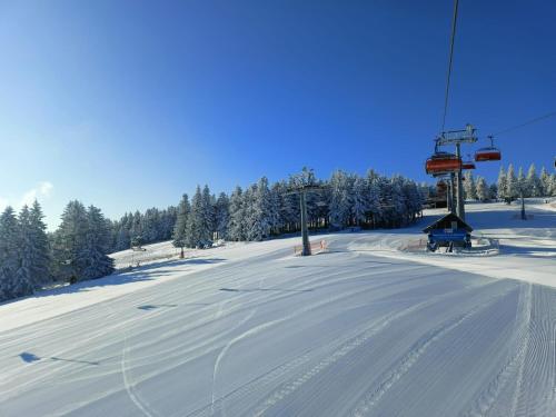a snow covered ski slope with a ski lift at Hotel Adam & Spa in Kudowa-Zdrój