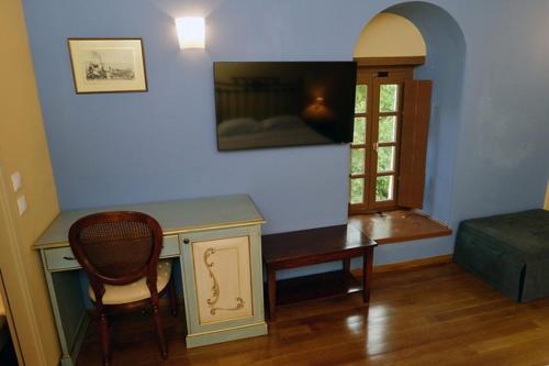 a room with a desk and a chair and a bed at Archontiko Leontari in Leondari
